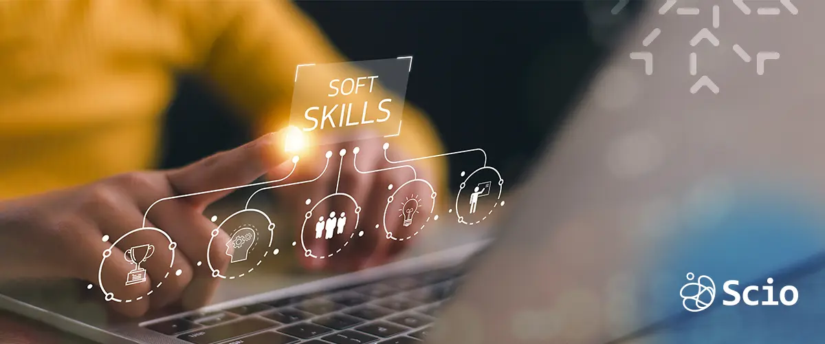 Engineer typing on laptop with hologram icons of soft skills for remote communication
