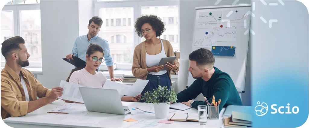 Engineering mentorship program: software development team collaborating in an open workspace representing the learning culture and knowledge-sharing environment that Sensei-Creati builds