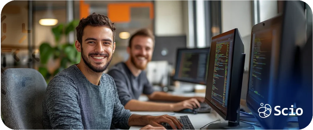 Junior vs senior developer: two software engineers at workstations at different experience levels collaborating in a modern engineering environment