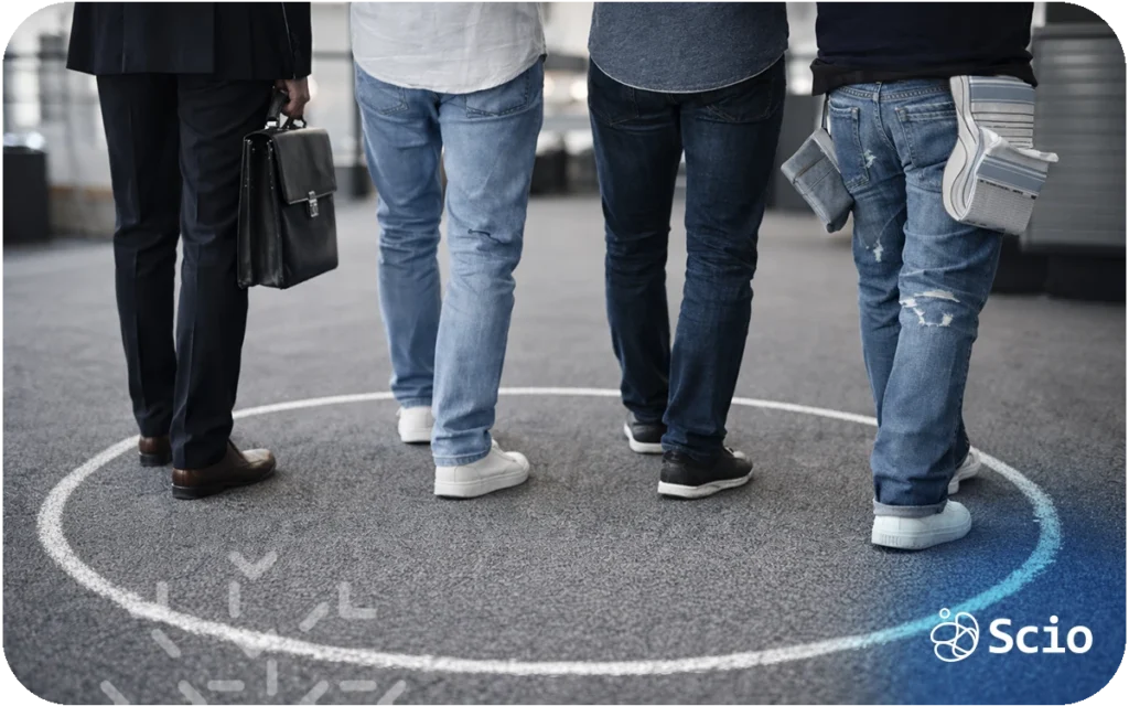 Three professionals standing inside a drawn circle on the floor, symbolizing comfort zones in engineering teams.