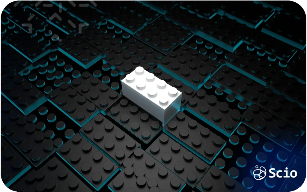 White LEGO brick placed on a dark modular surface, representing structured building blocks and system design.