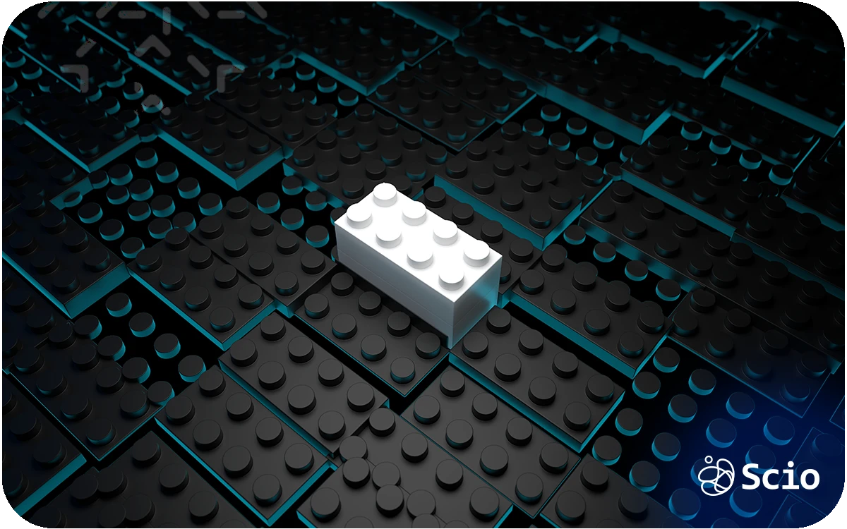 White LEGO brick placed on a dark modular surface, representing structured building blocks and system design.