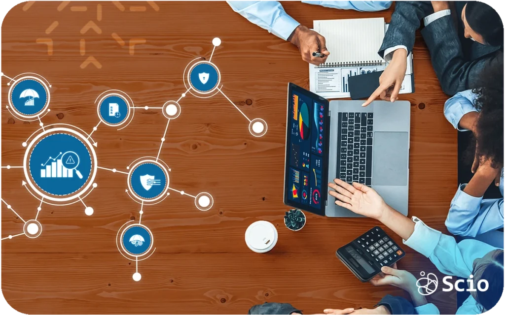 Team of IT professionals collaborating on a laptop with digital network icons representing technology challenges.