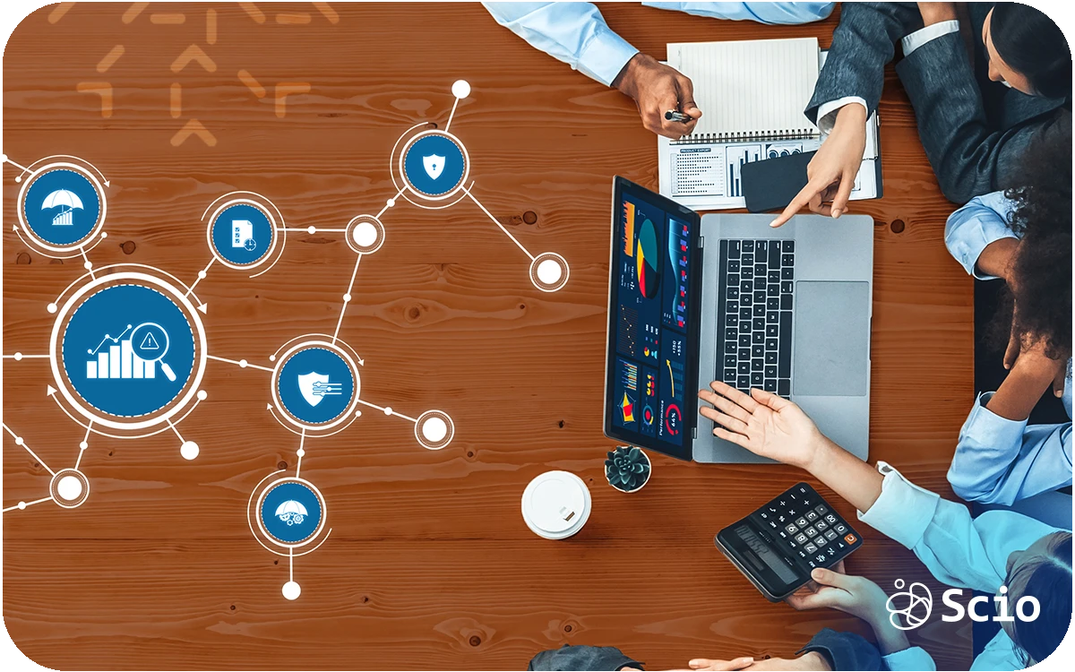 Team of IT professionals collaborating on a laptop with digital network icons representing technology challenges.