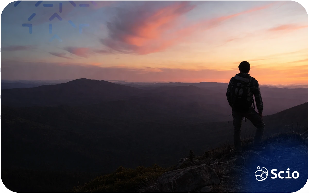 Engineer standing on a mountain peak at sunrise, symbolizing leadership perspective and long-term progress