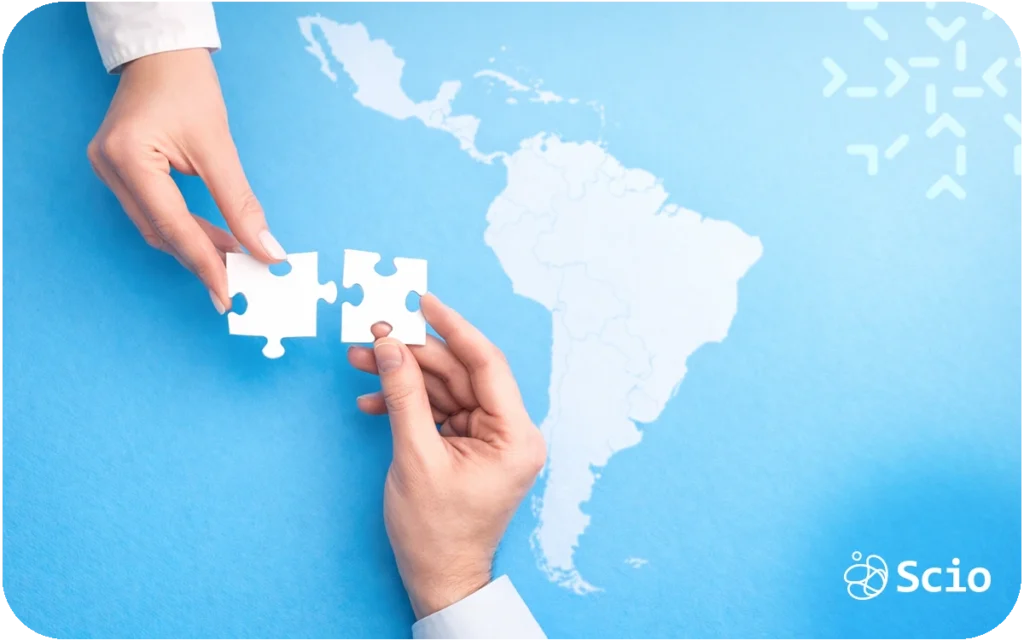 Hands placing a puzzle piece over a map of Latin America representing alignment between U.S. companies and nearshore engineering partners.