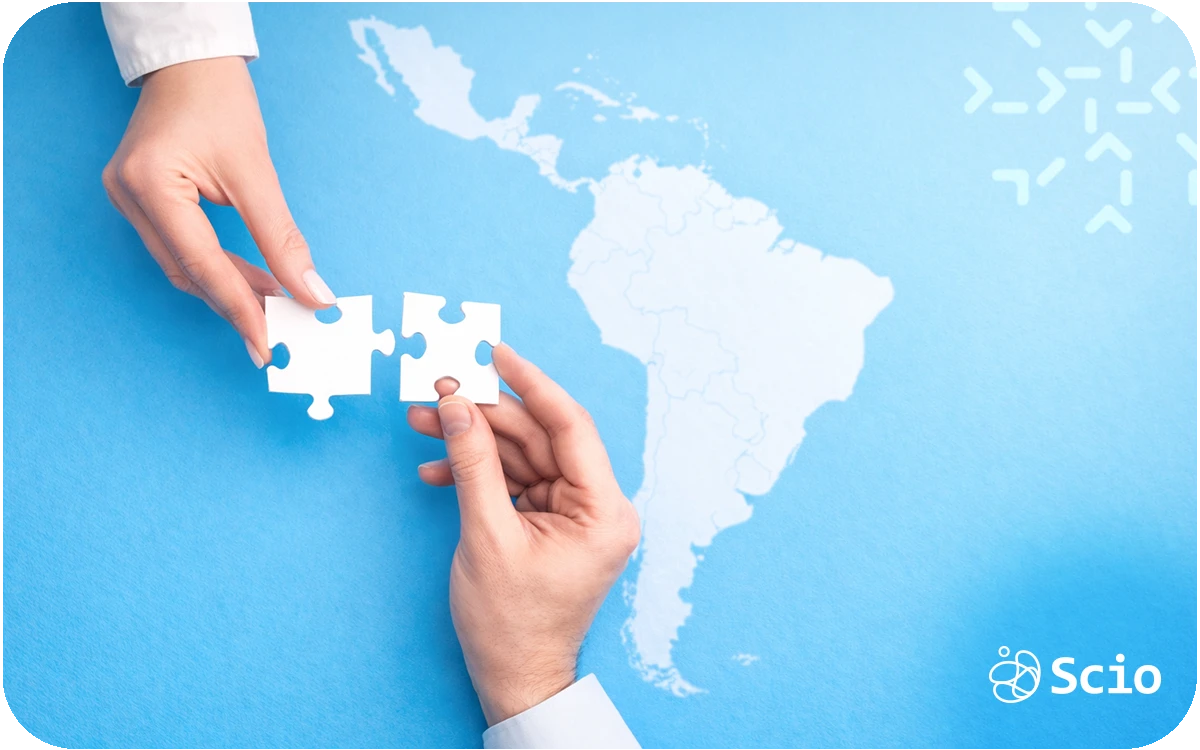 Hands placing a puzzle piece over a map of Latin America representing alignment between U.S. companies and nearshore engineering partners.