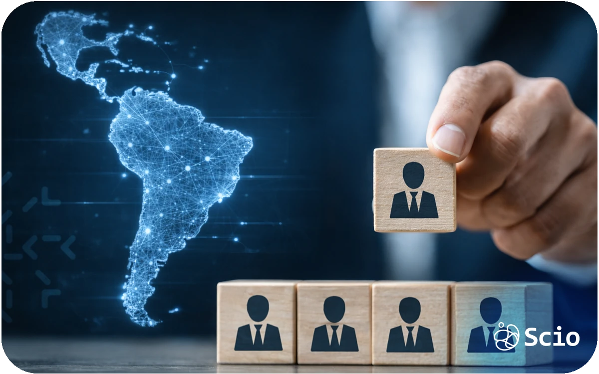 Executive placing a team member block while a digital map of Latin America glows in the background, symbolizing international team expansion.