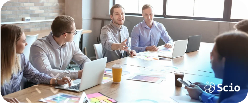 "Daily scrum best practices: engineering team in a focused standup meeting representing alignment, blocker removal, and outcome-focused collaboration in modern software delivery