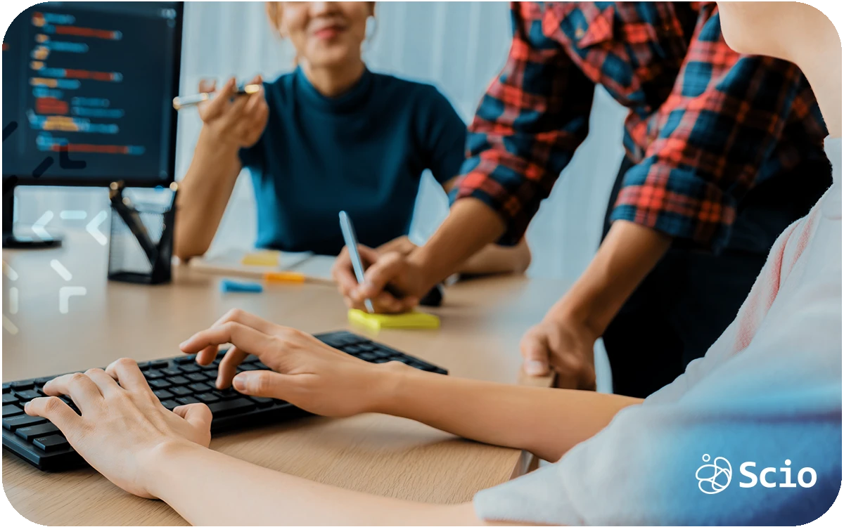 Software developers collaborating at a workstation, representing modern developer experience and team collaboration