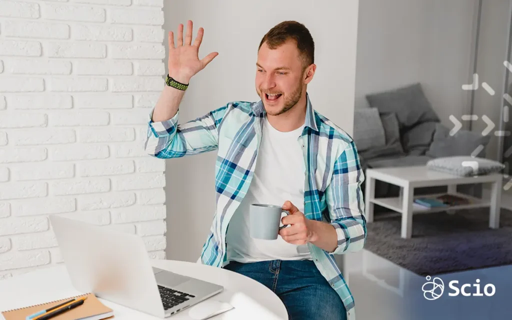 Employee wellbeing in remote teams: engineer smiling during a remote video meeting symbolizing genuine engagement connection and psychological safety in a distributed software team