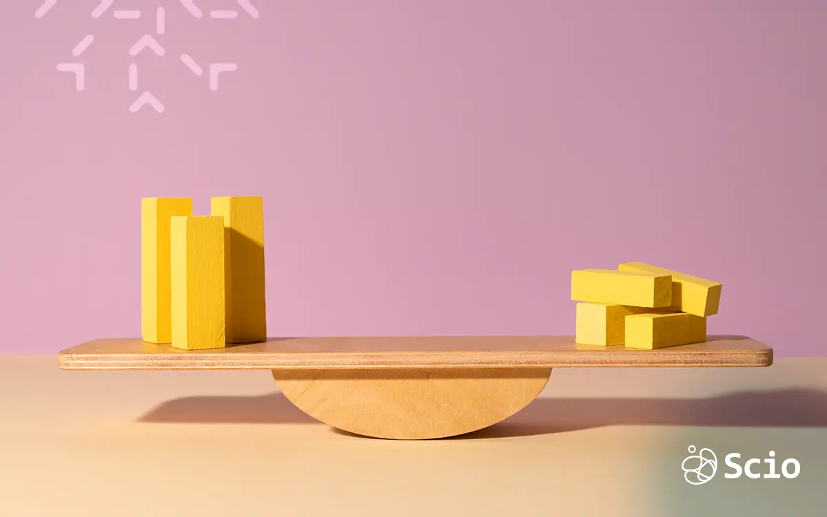 Wooden scale with yellow blocks representing technical debt and misaligned expectations imbalance