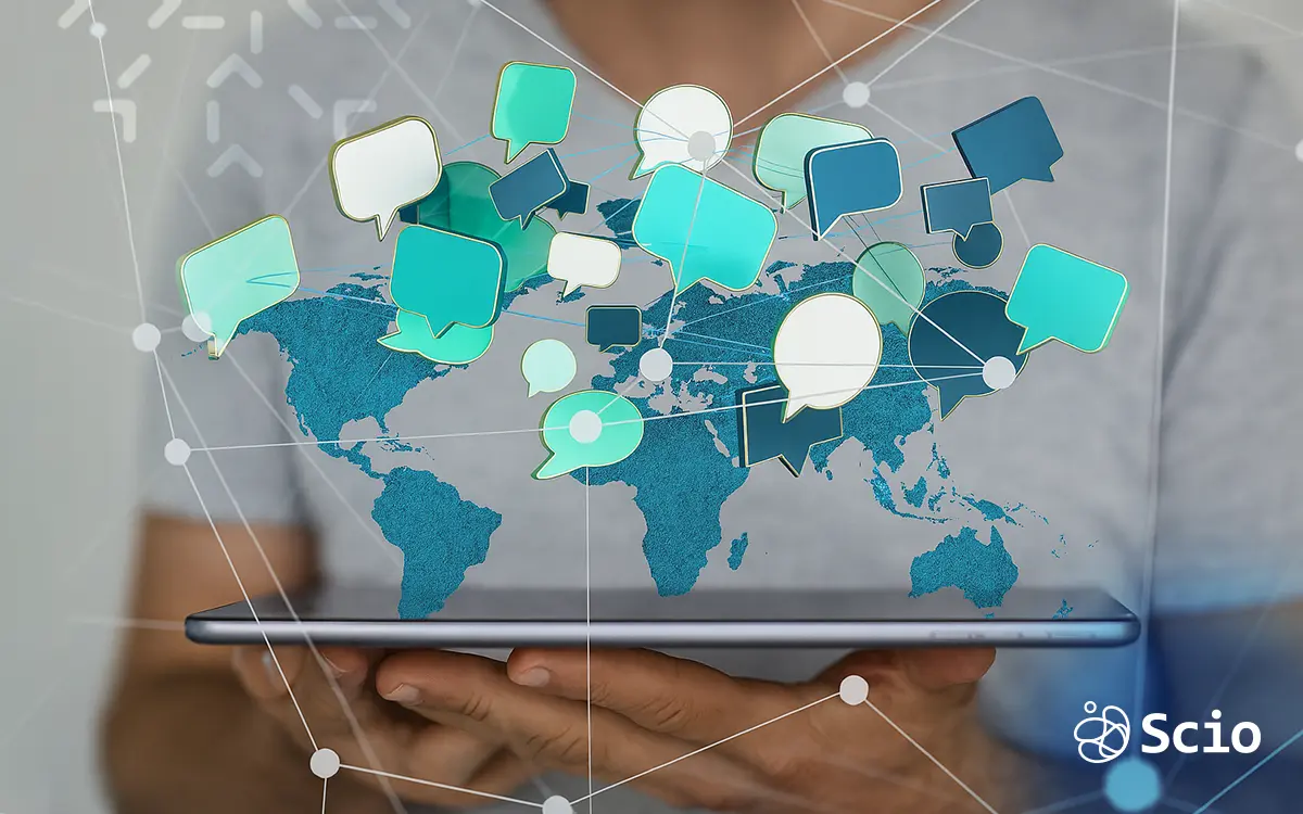 Digital speech bubbles over a world map on a tablet, representing global communication challenges in offshore software development