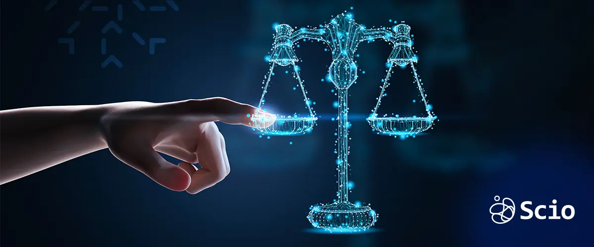 Legal and IP Risks in Offshore Contracts – Blog Scio Digital scale of justice being touched by a hand, symbolizing legal protection in software contracts