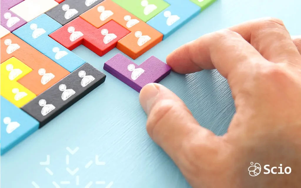 Outsourcing body shop: hand placing a missing puzzle piece shaped like a person representing the team structure decisions involved in choosing between a body shop and a full-service nearshore partner