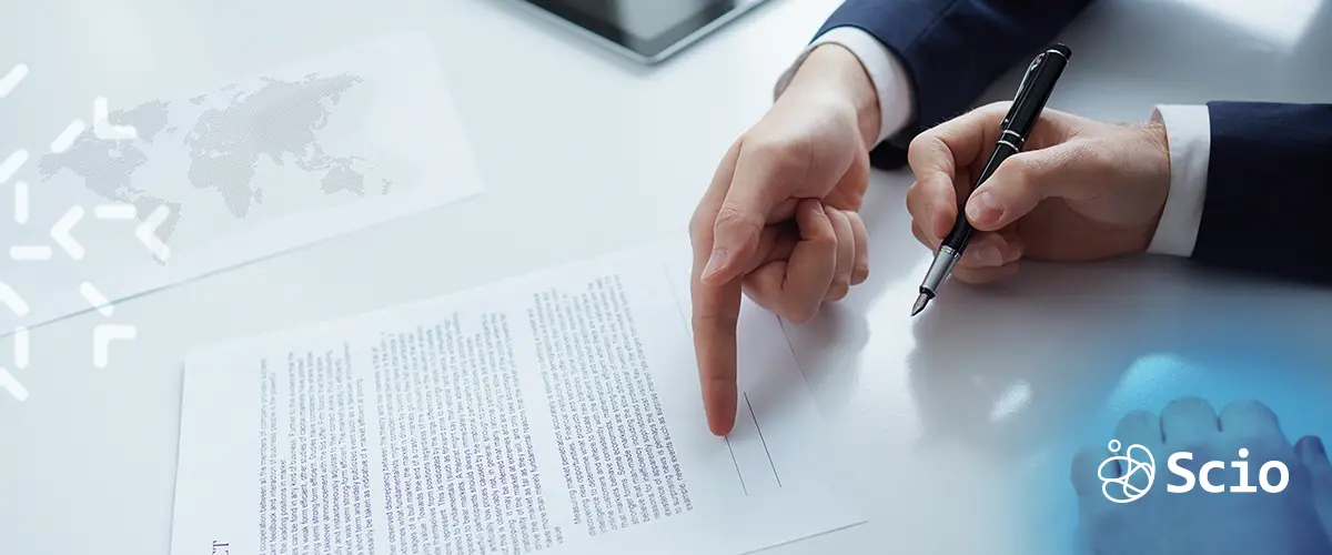 Offshore Contract Signing – NDA and Confidentiality Section Two professionals reviewing and signing a contract document, symbolizing NDA and confidentiality clauses in offshore software agreements