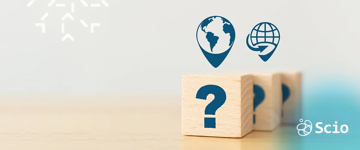 Wooden blocks with question marks and global location icons, symbolizing common doubts about nearshore and offshore outsourcing