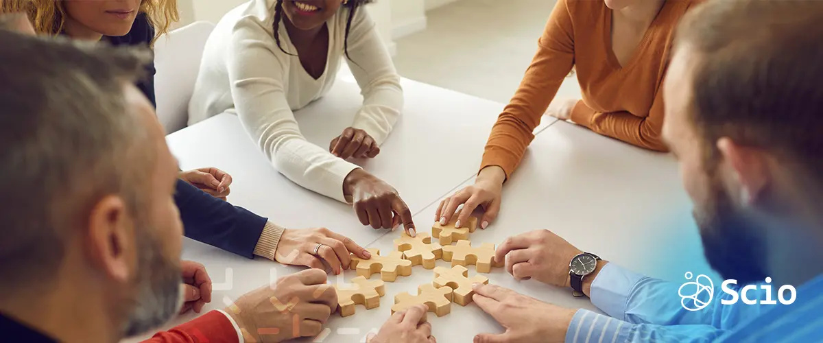 Shared Value in Product Strategy - Main Blog Image Team collaborating around a shared project, symbolizing how Shared Value in product strategy combines profitability with positive social impact.
