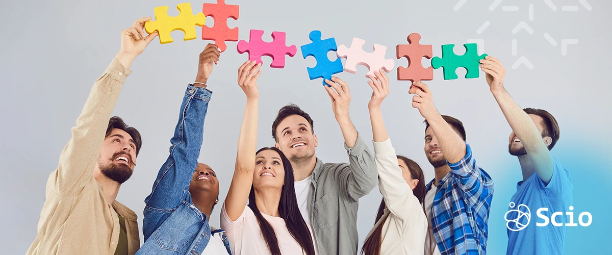 Latin American software team celebrating cultural alignment with puzzle pieces — nearshore collaboration for U.S. tech companies in Austin and Dallas.