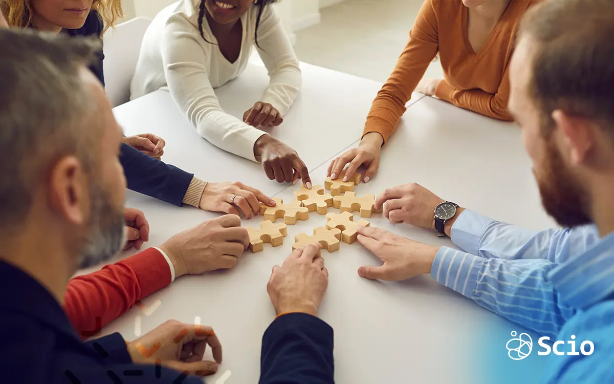 Team collaborating around a shared project, representing how Shared Value in product strategy connects business success with societal benefits.