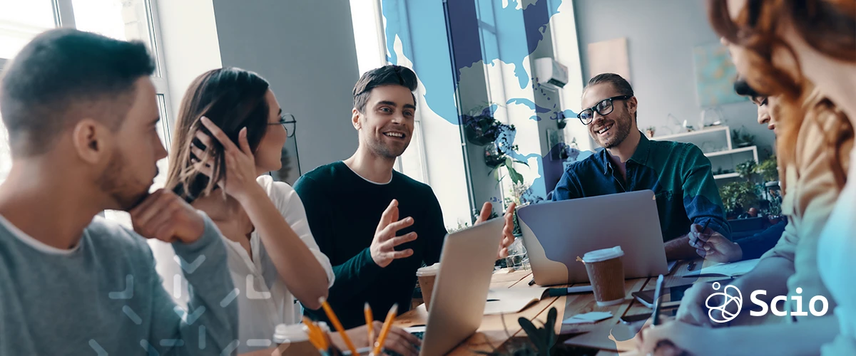 Team of nearshore software developers in Mexico and the U.S. collaborating in a modern meeting room, discussing project strategy and communication flow.