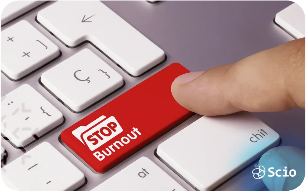 Keyboard key labeled “Stop Burnout” being pressed, representing early detection and prevention of burnout in software teams.