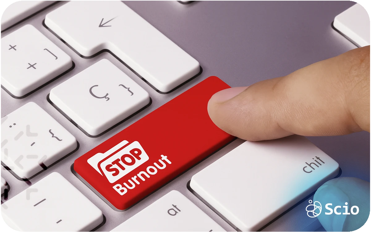 Keyboard key labeled “Stop Burnout” being pressed, representing early detection and prevention of burnout in software teams.