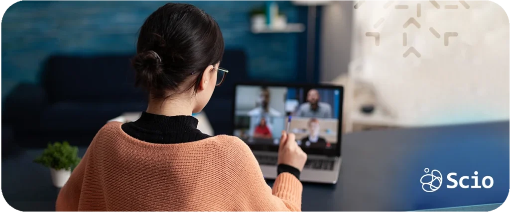 Distributed team trust: nearshore software engineer in a remote workspace connecting with her distributed team through a video meeting symbolizing the human infrastructure of trust across screens