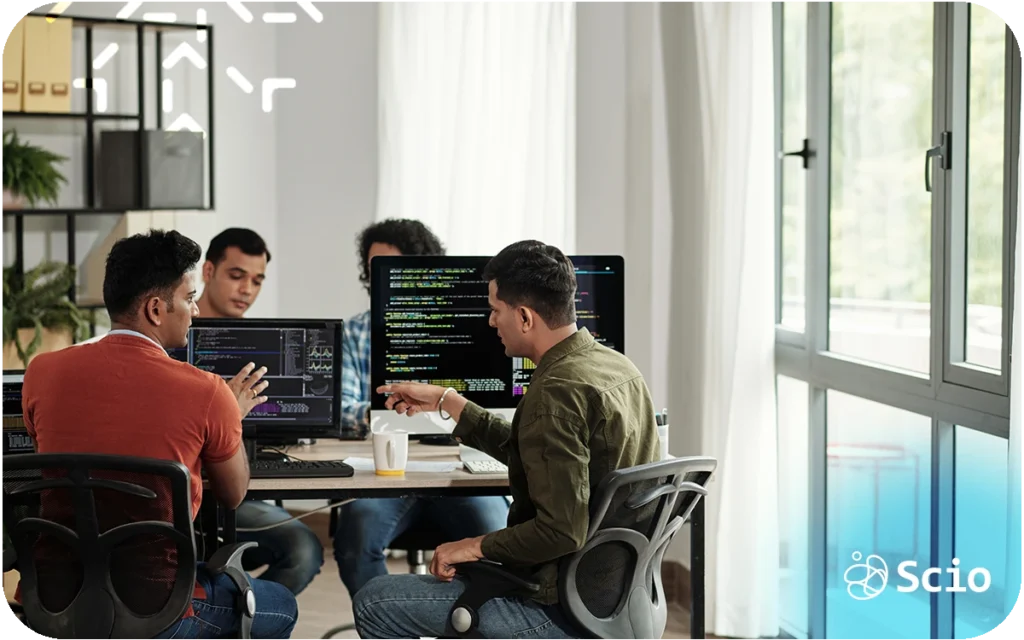 SSoftware development skills beyond code: engineering team in collaborative discussion representing how communication, judgment, and collaboration determine real delivery outcomes beyond technical execution