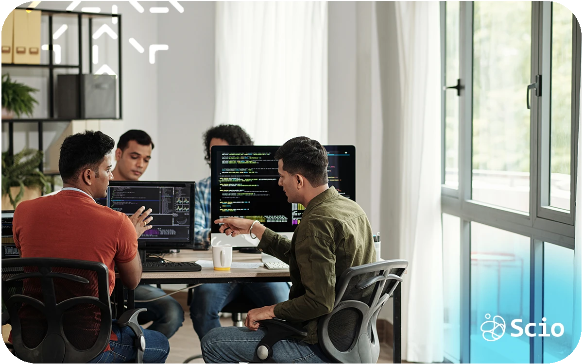 SSoftware development skills beyond code: engineering team in collaborative discussion representing how communication, judgment, and collaboration determine real delivery outcomes beyond technical execution
