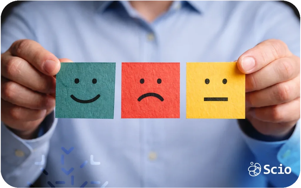 Engineering leader holding emotion cards representing the hidden emotional cost of leadership and empathy fatigue