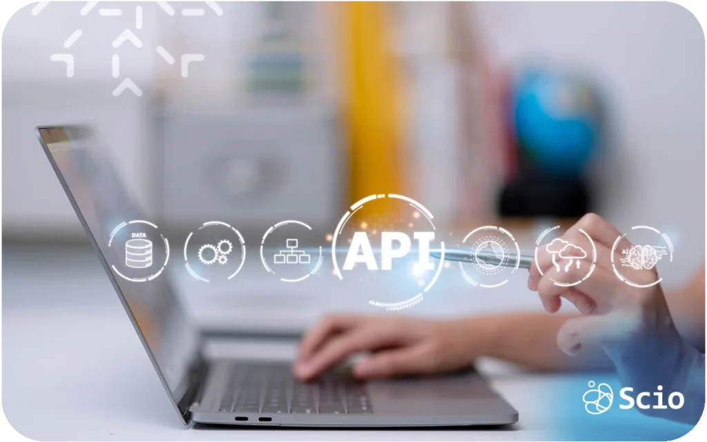 Developer working on a laptop with fintech and API icons representing the complexity of building secure financial applications
