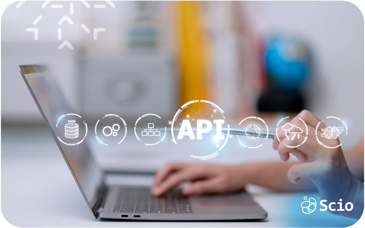 Developer working on a laptop with fintech and API icons representing the complexity of building secure financial applications