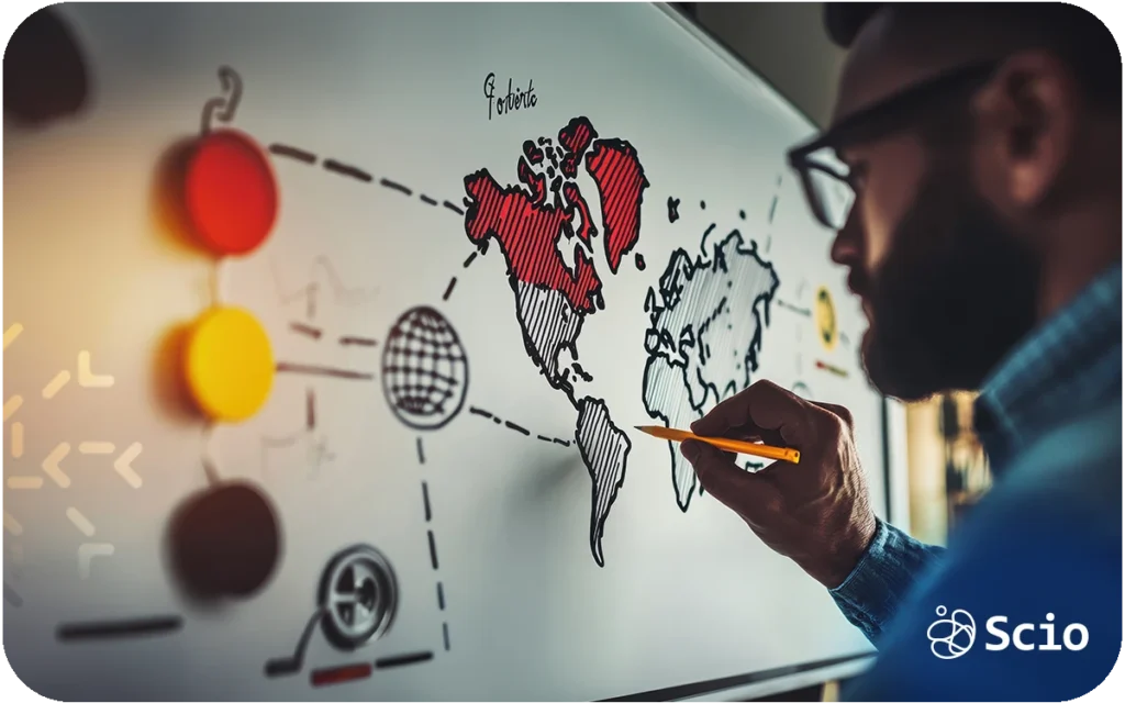 Software development manager analyzing a world map while planning outsourcing strategy to Latin America