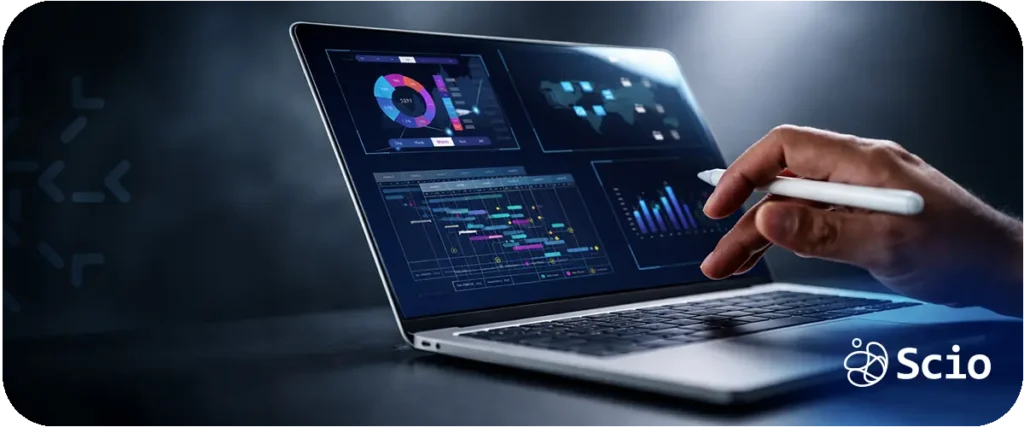 Engineer monitoring AI analytics dashboards on a laptop to track system stability and operational performance.