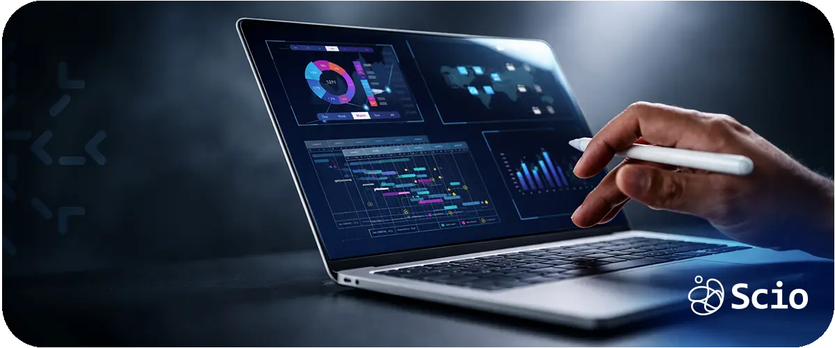 Engineer monitoring AI analytics dashboards on a laptop to evaluate system stability and operational performance